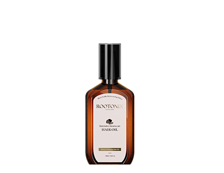 Elegant amber bottle of Rootonix Intensive Moroccan Hair Oil, enriched with Moroccan argan oil and black truffle for hair repair